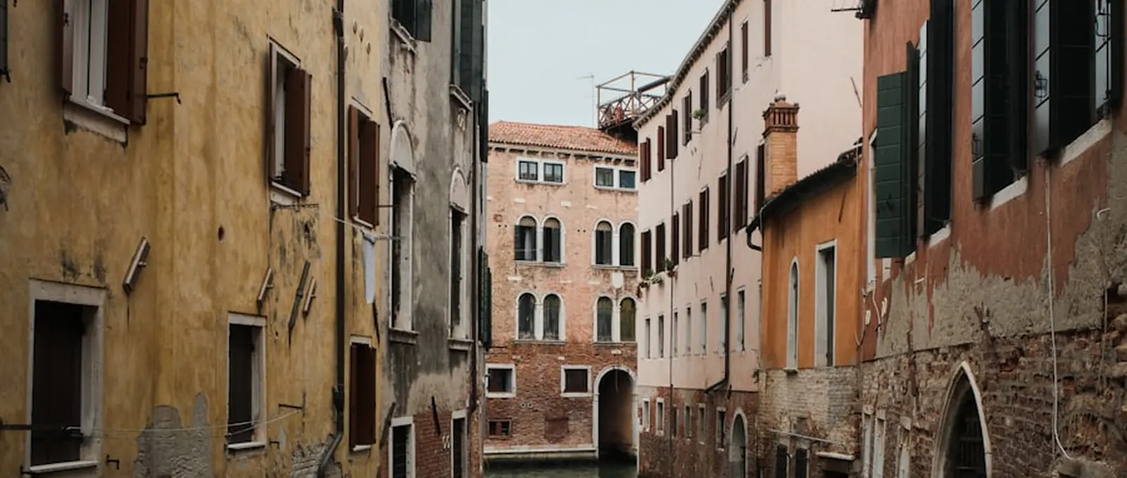 A quiet canal between Venetian houses.